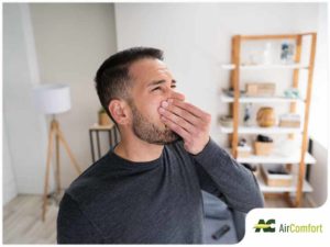 man pinching nose shut to avoid smell